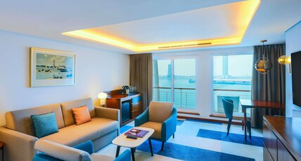 Queen Elizabeth 2 Room Type - Duplex Suite with 1 King size bed and separate living room area with a sofabed