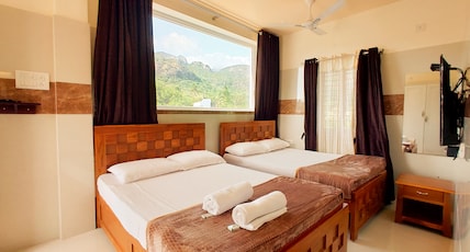 Kutralam Ezhilagam Hotel Room Type - Deluxe Studio Room with Mountain view (A/C ) - KURINJI Kutralam Ezhilagam Hotel Room Type - Deluxe Studio Room with Mountain view (A/C ) - KURINJI