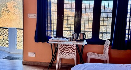 SamathaStay Room Type - Bedroom 2 with shared balcony and mountain view