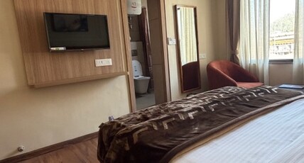 hotel shiva Room Type - King Bed Room with city and hill view