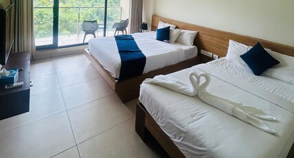 Mount view by farstay Room Type - Hill view balcony Quad bed deluxe room non AC