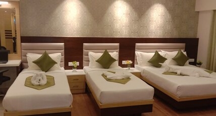 Vanusa Residency Room Type - Deluxe Suite Room ( 1 King Bed & 2 Single beds)