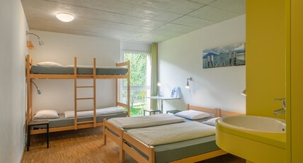 Backpackers Villa Sonnenhof - Hostel Interlaken Room Type - Comfort Quad Room- 2 Twin Beds and 1Bunk Bed