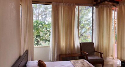 Lazy Days Room Type - Non AC Deluxe room with balcony and forest view.