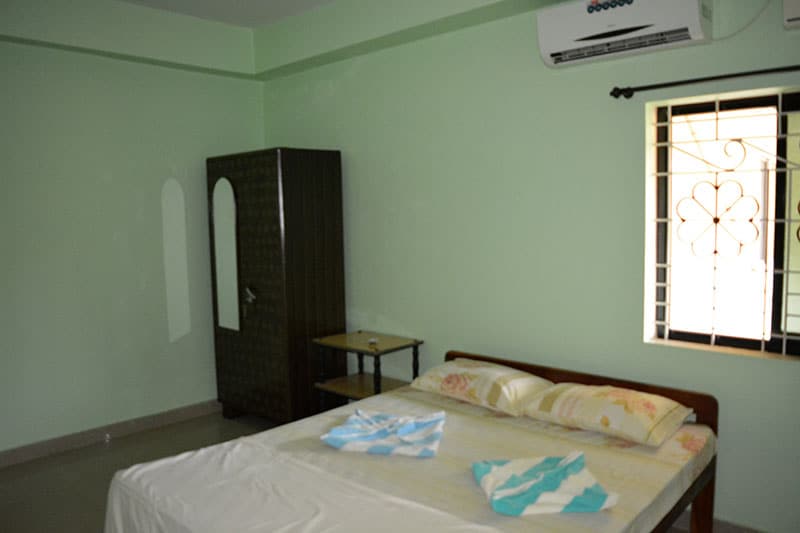 Vailankanni Guesthouse | Rooms & Kitchen - Tap to explore photos