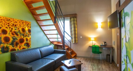 ibis Styles Bourges Room Type - Privilege Room with a double bed and a sofa
