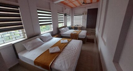 Karthika Homestay Room Type - Family Room with One king size and Two queen size cots.