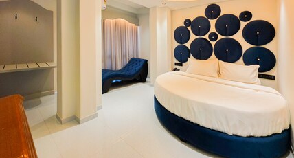 Hotel Nova Bloom Room Type - Premium Round Bed Suite with 245 Sofa and 55 Inch Android Smart T.v for Netflix and Chill