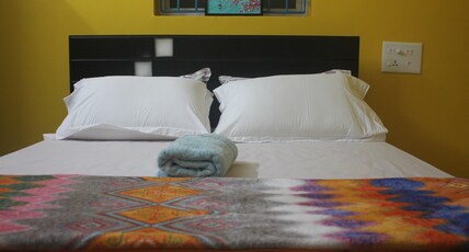 Studio Room Near DLF and Chennai Trade Centre Room Type - Yellow Bedroom