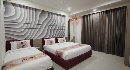 THE PUSHP RESIDENCY Room Type - Deluxe Triple Bed