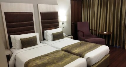 Mahagun Sarovar Portico Suites Room Type - Studio Room Twin Beds