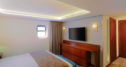 Queen Elizabeth 2 Room Type - Officer Suite with 1 King Size bed and Sofa Bed
