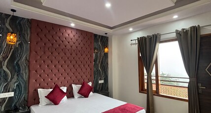 Kabir Heights Room Type - Premium room with an attached balcony and mountain views.