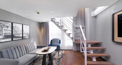 Mercure Surabaya Manyar Room Type - Executive Suite with sofa and dining table, duplex suite, queen bed, non smoking