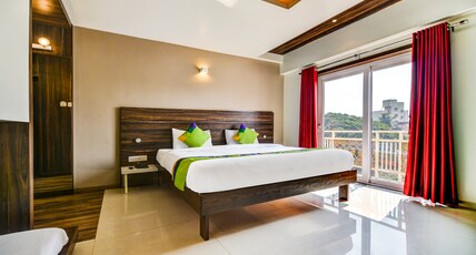 Treebo Shree Sai Suites Room Type - Deluxe Room with Balcony